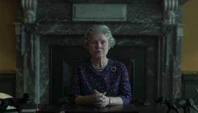 Imelda Staunton as Queen Elizabeth II sits at her desk in The Crown, Season 6, Part 2