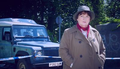 Brenda Blethyn as DCI Vera Stanhope standing in front of her car in 'Vera' Season 13
