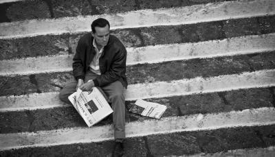 Andrew Scott as Tom Ripley sits dejectedly on the stairs in 'Ripley'