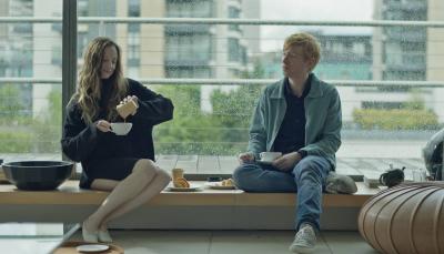 Andrea Riseborough and Domhnall Gleeson as the titular 'Alice & Jack' sitting in a window