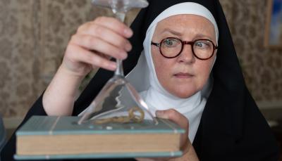 Lorna Watson as Sister Boniface captures a scorpion under a glass in 'Sister Boniface Mysteries' Season 3