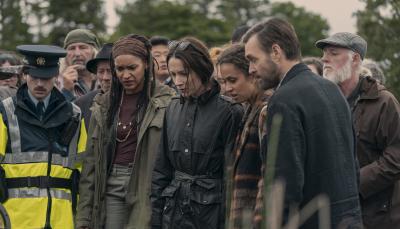 Seán Óg Cairns as Garda Eoin, Kerri McLean as Maeve, Siobhán Cullen as Dove, Robyn Cara as Emmy Sizergh, and Will Forte as Gilbert Power stand over a dead body in 'Bodkin'