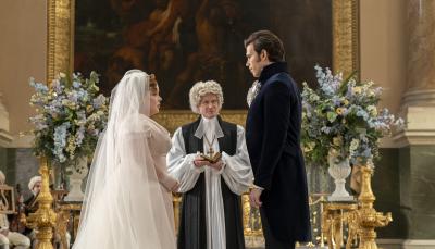 Nicola Coughlan as Penelope Featherton and Luke Newton as Colin Bridgerton at the altar in 'Bridgerton' Season 3