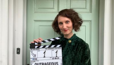 Bessie Carter holds the clapper to mark the start of filming on Outrageous