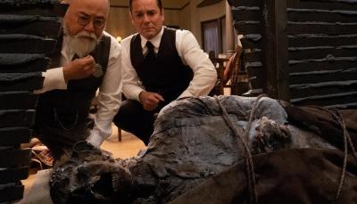 Paul Sun-Hyung Lee as Inspector Albert Choi and Yannick Bisson as William Murdoch examine a body in a wall in 'Murdoch Mysteries' Season 18