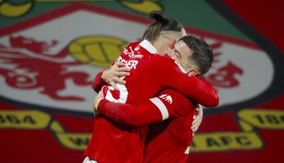 Players Steven Fletcher and Elliot Lee celebrate on the pitch of 'Welcome to Wrexham' Season 4