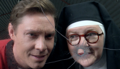 Picture shows: Sister Boniface (Lorna Watson and DI Sam Gillespie (Max Brown) peer through a window with a bullet hole.