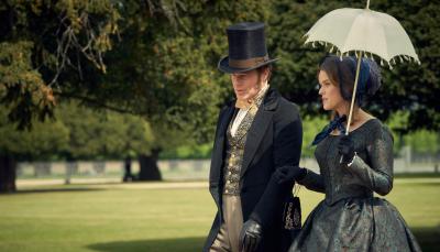 Richard Goulding and Alice Eve as Oliver and Susan Trenchard walk arm in arm through the parkin 'Belgravia' Season 1