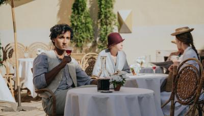 Assad Zaman as Anish Sengupta drinks and contemplates in 'Hotel Portofino' Season 1