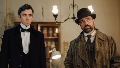 Picture shows: Matthew Beard as Max Liebermann Juergen Maurer as Oskar Reinhardt in a drawing room in Vienna Blood Season 2