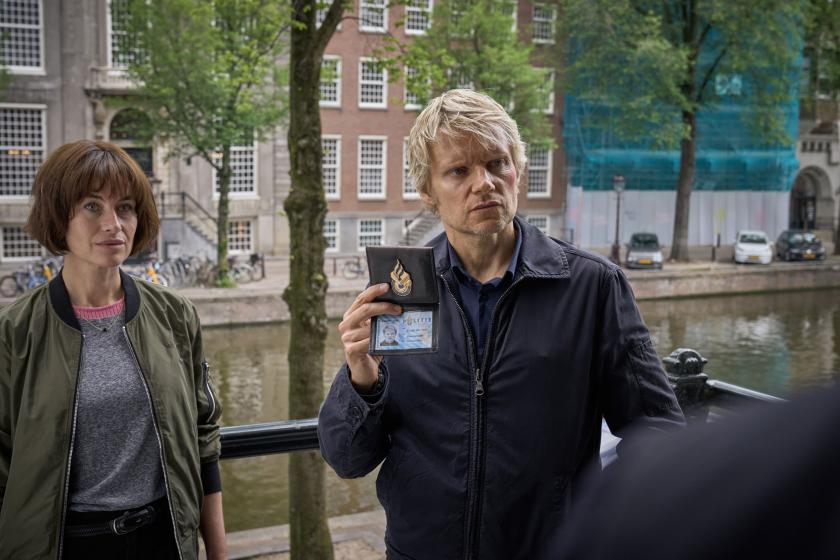 Picture shows: Maimie McCoy as Lucienne Hassel and Marc Warren as Piet Van der Valk in Van der Valk Season 2