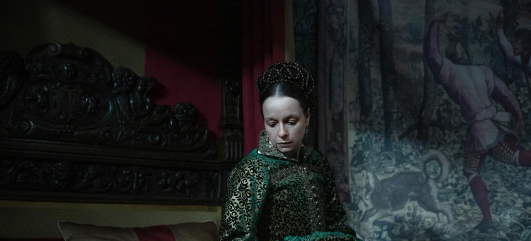 Picture shows: Samantha Morton as Catherine wearing a green gown and sitting on a bed.