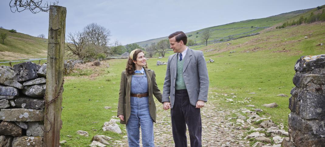 Picture shows: On a sunny day in the Dales, James (Nicholas Ralph) and Helen (Rachel Shenton) hold hands, paused on a rough track flanked by drystone walls. 