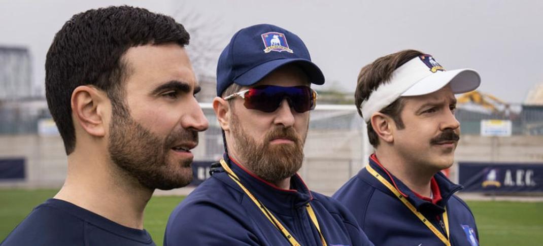 Brett Goldstein as Roy Kent, Brendan Hunt as Coach Beard, and Jason Sudeikis as Ted Lasso in 'Ted Lasso' Season 3, Episode 1