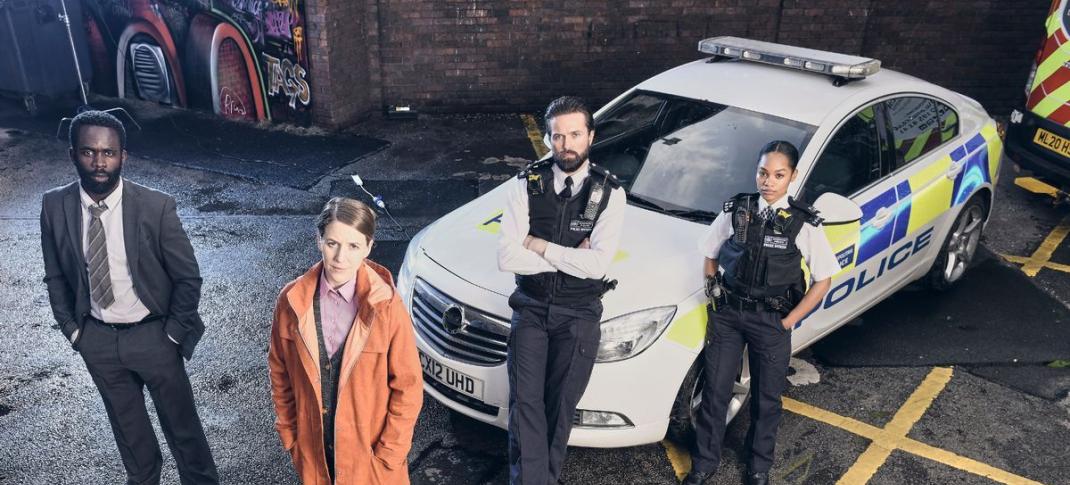 Picture shows: DC Steve Bradshaw (Jimmy Akingbola), DS Sarah Collins (Gemma Whelan), DI Kieran Shaw (Emmett J. Scanlan), PC Lizzie Adama (Tahirah Sharif) stand by a police car, looking upward.