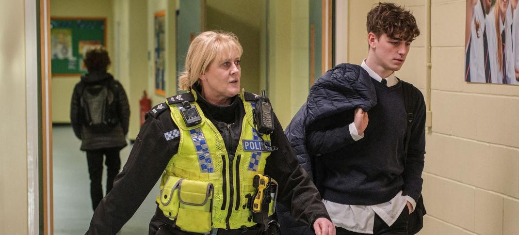 Sarah Lancashire as Catherine and Rhys Connah as Ryan walking the school hallways in Happy Valley Season 3