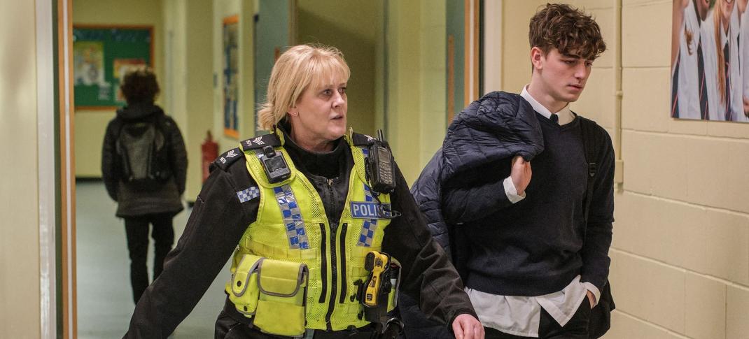 Sarah Lancashire as Catherine and Rhys Connah as Ryan walking the school hallways in Happy Valley Season 3 