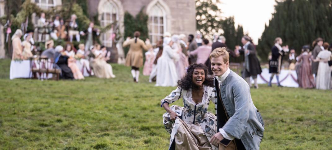 Picture shows: Tom Jones (Solly McLeod) and Sophia (Sophie Wilde) take a moment from the rowdy wedding celebration. They're outside on a green lawn that slopes away from a large stone house, outside of which are their wedding guests.