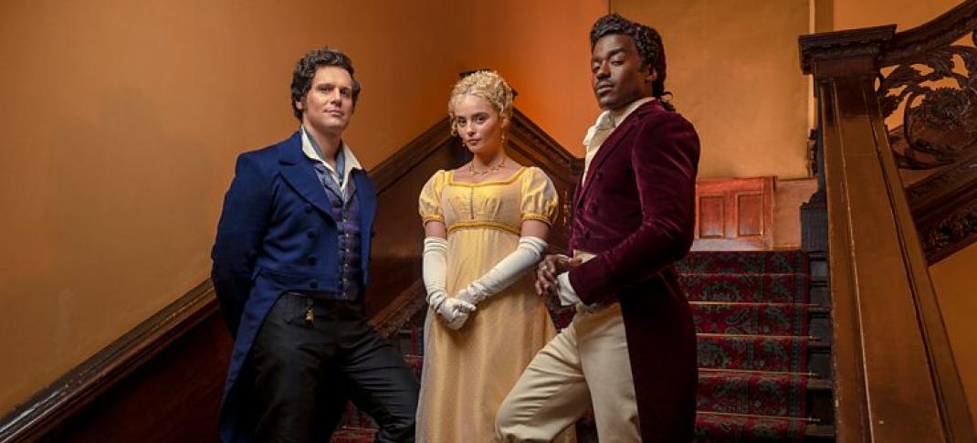 Jonathan Groff, Millie Gibson, and Ncuti Gatwa dressed in Regency era costumes standing on a staircase