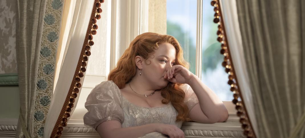 Nicola Coughlan as Penelope Featherington sadly in a window in Bridgerton Season 3
