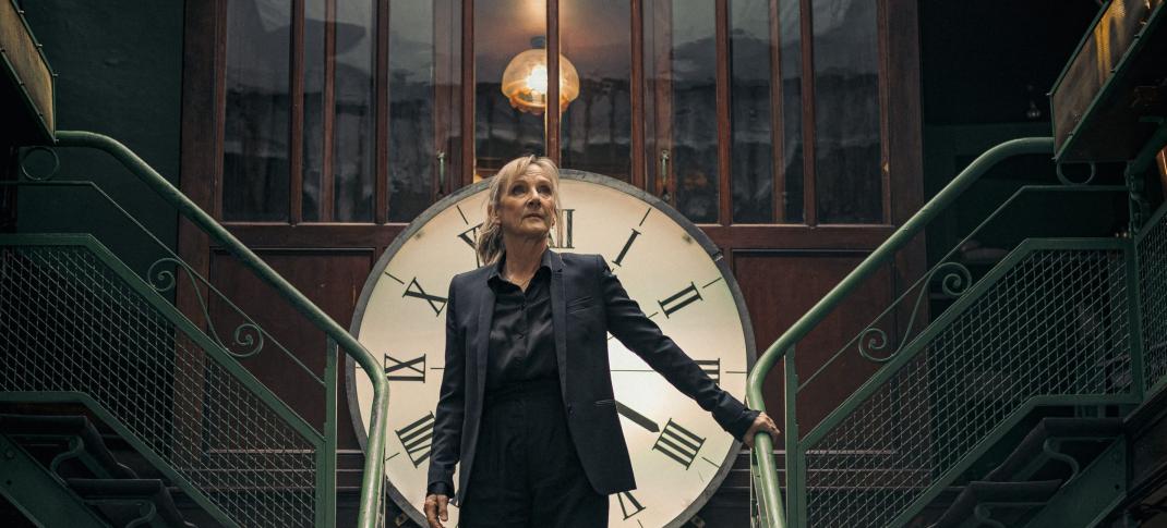 Lesley Sharp as Hannah Laing stands dramatically in front of a cockface on the stairs in Before We Die Season 2