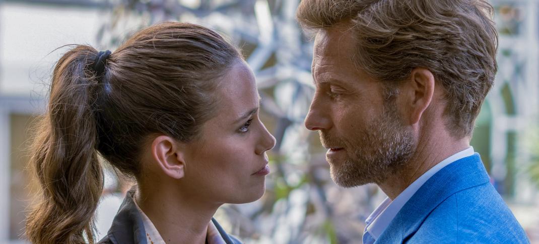 Harry King (Jamie Bamber) and Camille Delmasse (Lucie Lucas) look as though they're about to kiss.