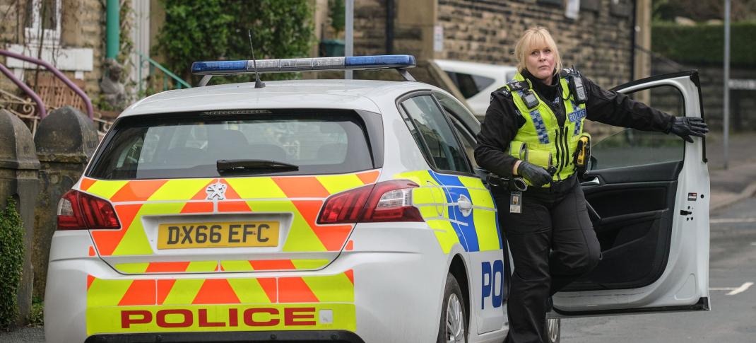 Sarah Lancashire as Catherine Cawood exits the police vehicle in Happy Valley Season 3