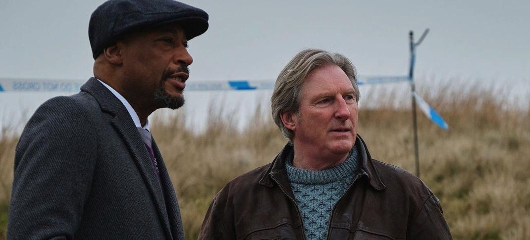 Terence Maynard as DCI Paul Goodwin and Adrian Dunbar as Alex Ridley stand in a field in Ridley Season 1