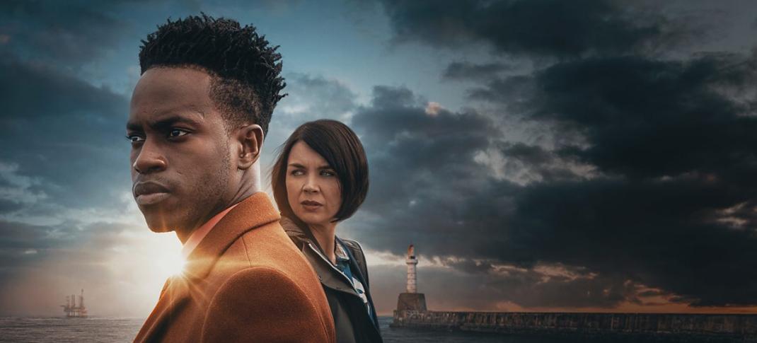 Romario Simpson as Davis Lindo and Hannah Donaldson DS Tara ‘Bart’ Bartlett stare across the water in Granite Harbour's key art