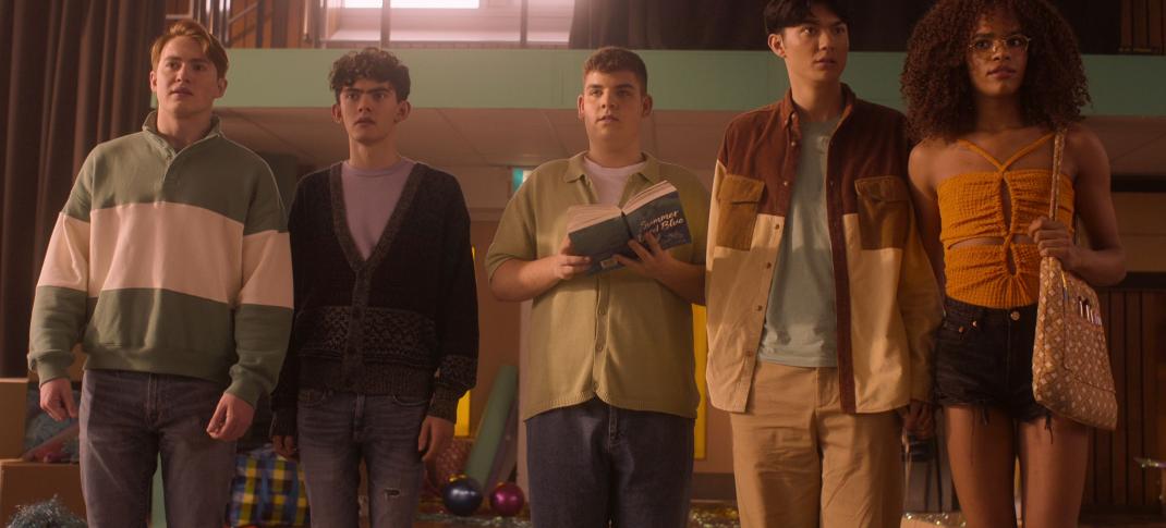 Kit Conner as Nick, Joe Locke as Charlie, Tobie Donovan as Isaac, William Gao as Tao, and Yasmin Finney as Elle stand in a messy school gym in 'Heartstopper' Season 2