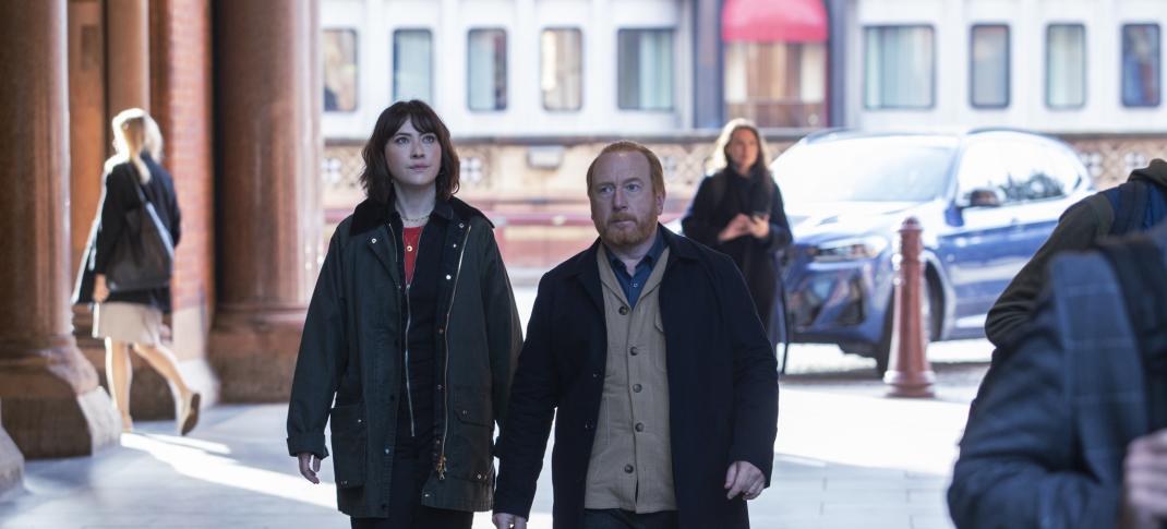 Adrian Scarborough as DI Max Arnold and Vanessa Emme as DS Layla Walsh walk down the street in The Chelsea Detective Season 2