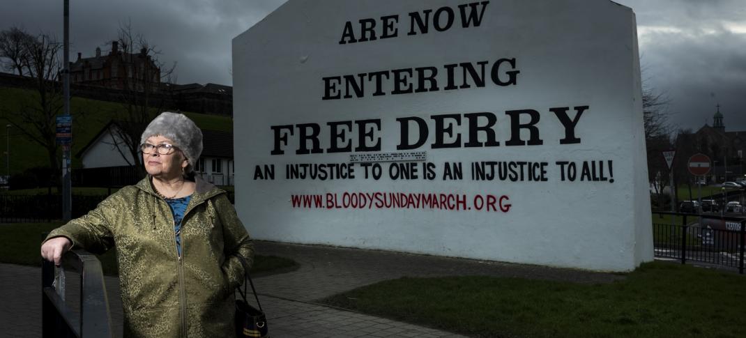 Kate, whose brother William was shot dead by paratroopers on Bloody Sunday, stands in front of the Free Derry sign in 'Once Upon A Time in Northern Ireland'