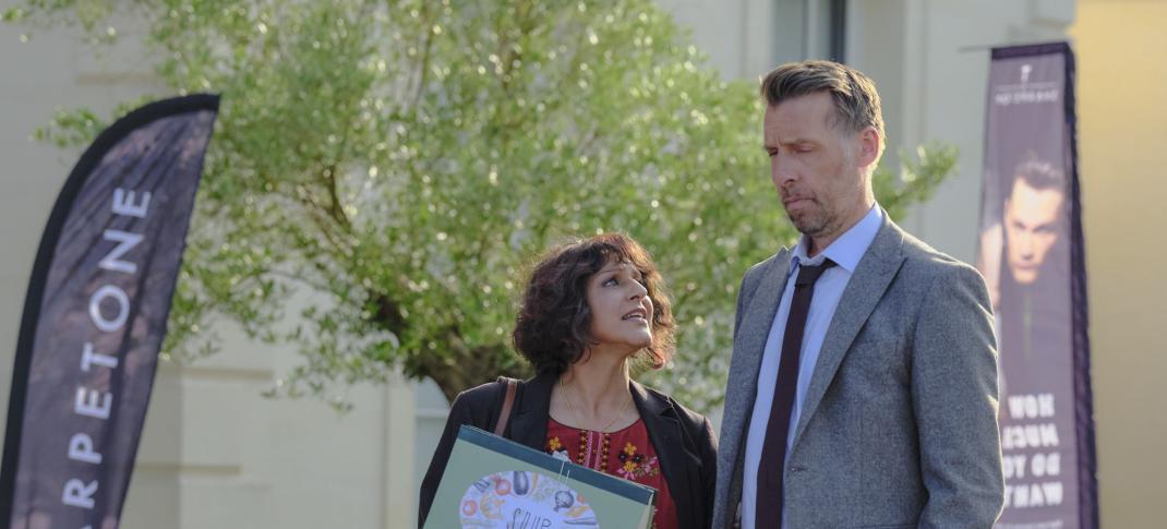 Meera Syal as Mrs. Sidhu and Craig Parkinson as DCI Burton discuss a case outside the precinct in 'Mrs Sidhu Investigates' Season 1