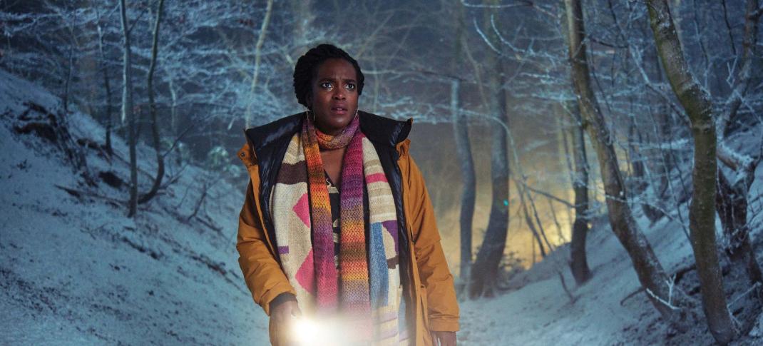 Wunmi Mosaku as Former Met Police Detective Riya Ajunwa searches through the snowy woods in 'Passenger'