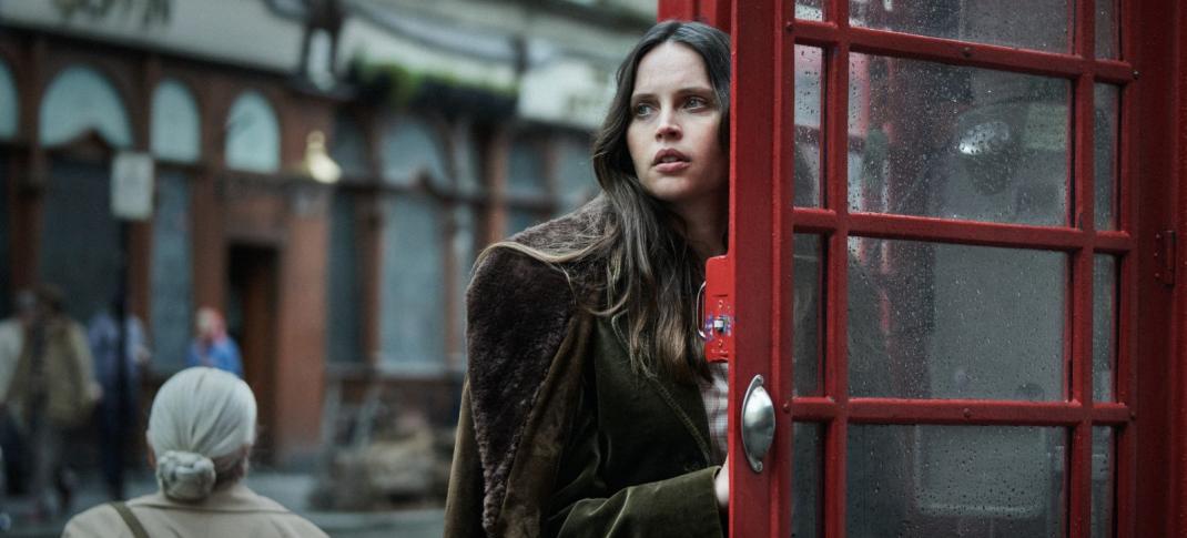 Felicity Jones as Catherine entering a telephone booth in 'Dead Shot'