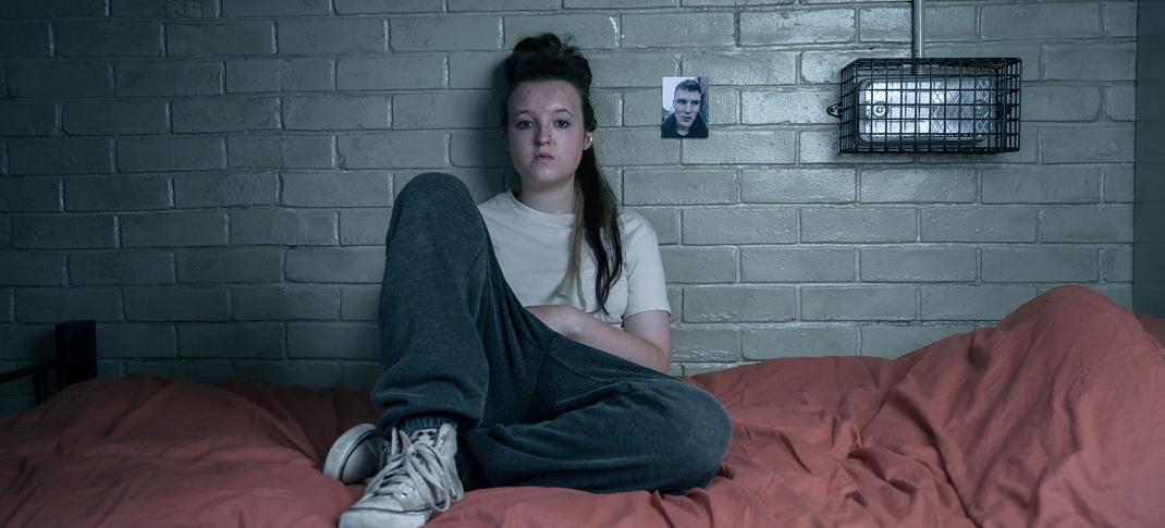 Bella Ramsey as Kelsey Morgan sits on her bed in Time Season 2