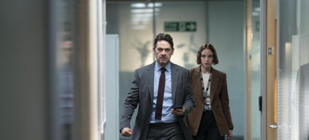 Dougray Scott as DI Ray Lennox and Joanna Vanderham walk down the hall of the office as DS Amanda Drummond in 'Crime' Season 2