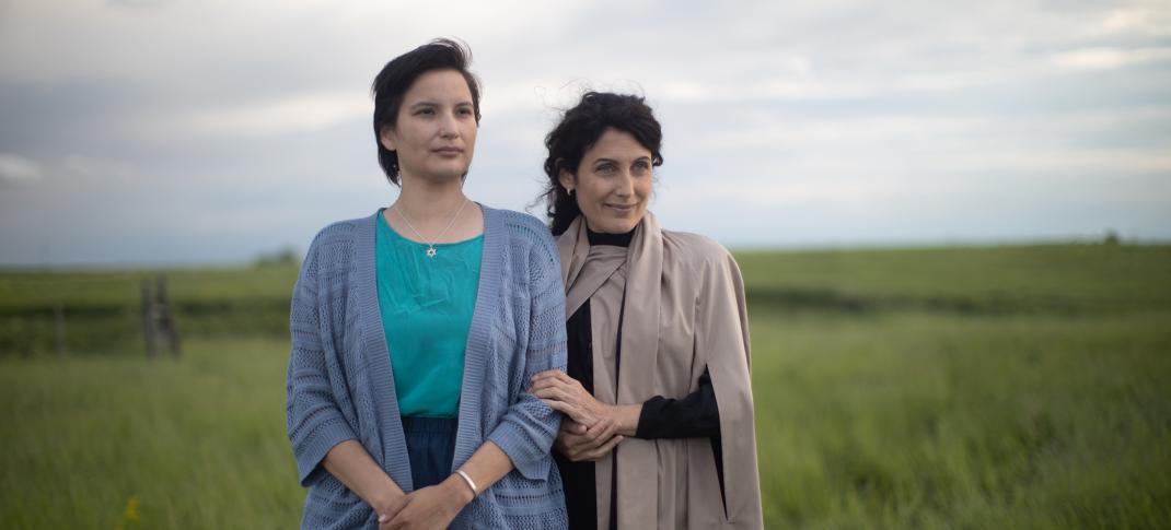Darla Contois as Esther and Lisa Edelstein as Golda stand on the plains of Winnipeg in 'Little Bird'