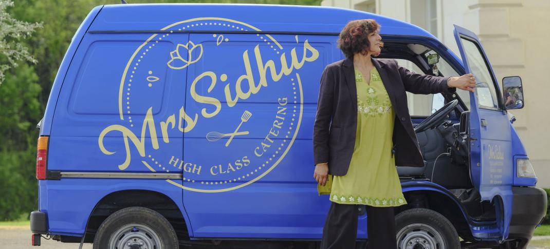 Meera Syal as Mrs. Sidhu stands in front of her food van in 'Mrs Sidhu Investigates' Season 1