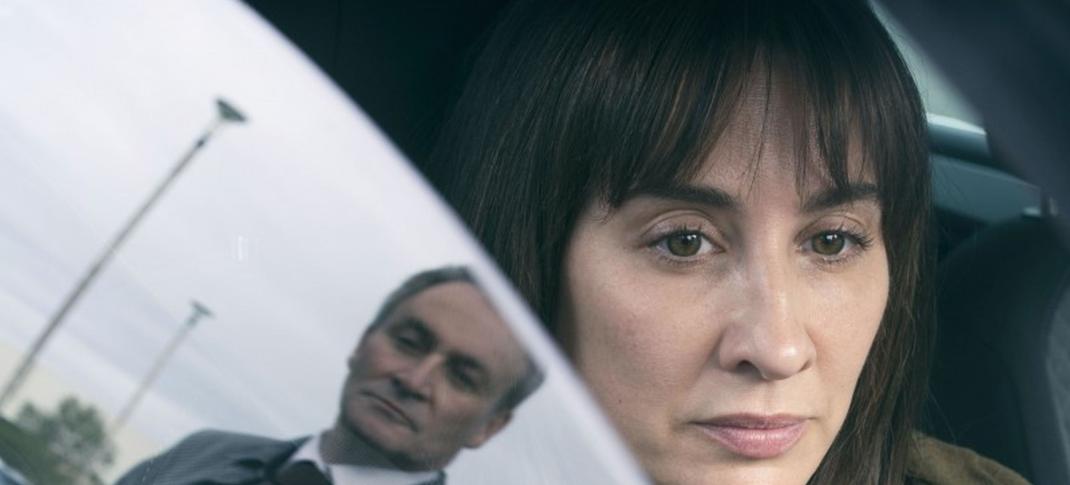 Derek Riddell as DCI Adam Guthrie gazes down at Morven Christie as Lexie Noble in her car in 'Payback'