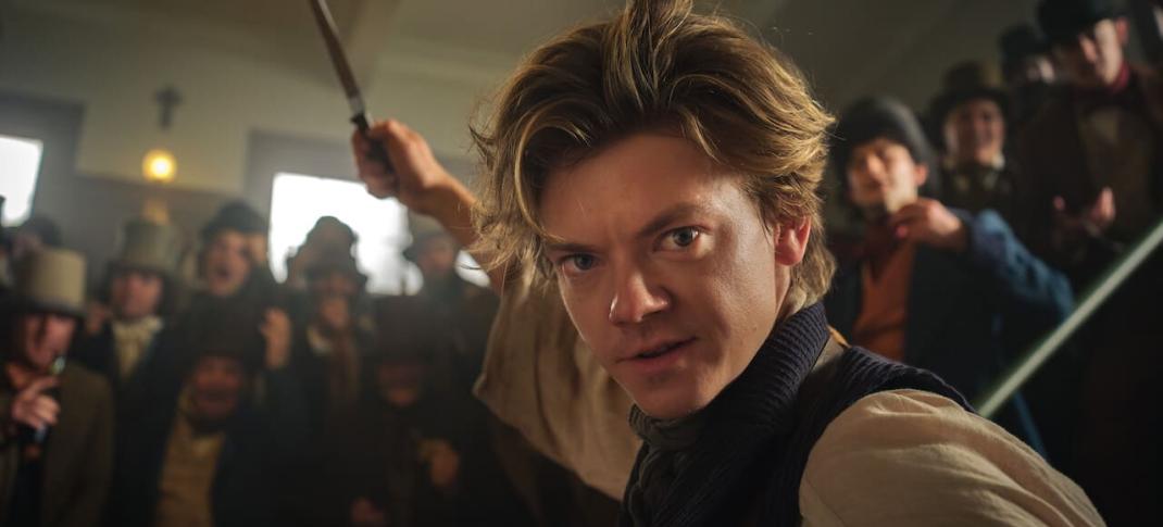 Thomas Brodie-Sangster as Jack brandishes a knife in The Artful Dodger