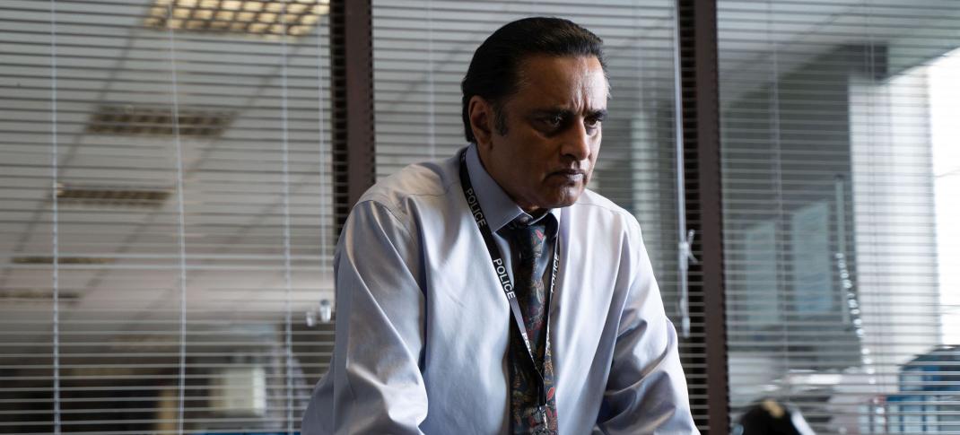 Sanjeev Bhaskar as DI Sunny Khan stands at his desk in 'Unforgotten' Season 5