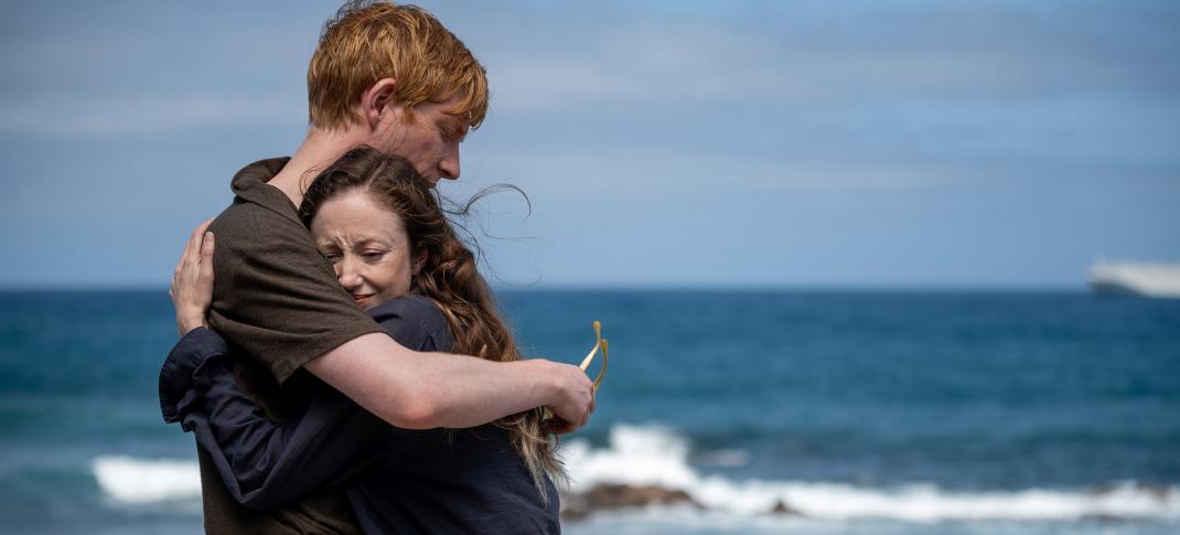 Domhnall Gleeson as Jack and Andrea Riseborough embrace by the ocean as Alice in 'Alice & Jack'