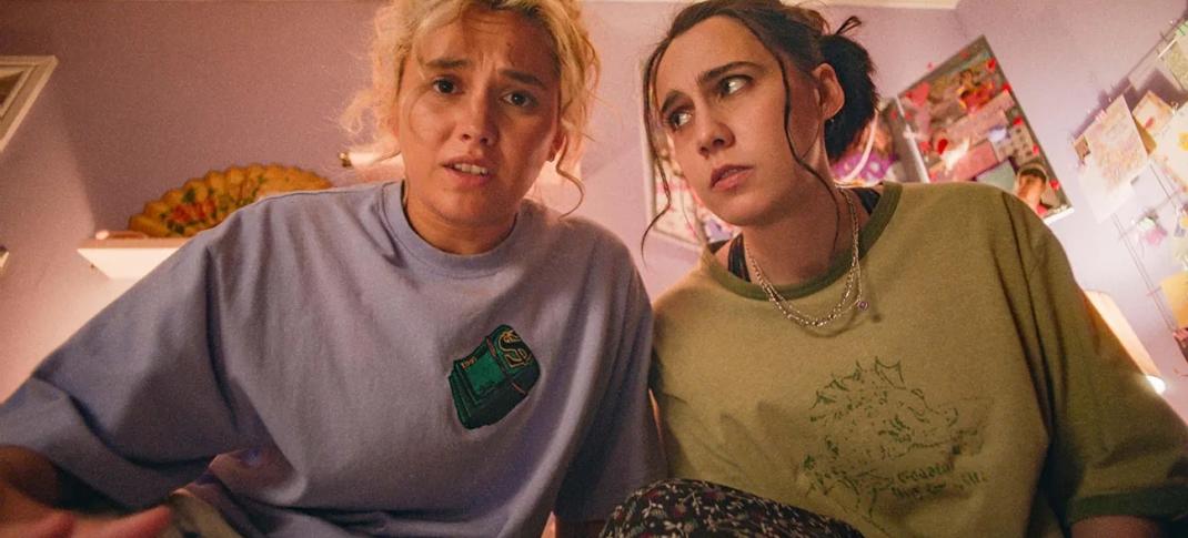 Kat Sadler as Josie, Lizzie Davidson as Billie stare in horror at something under the bed in 'Such Brave Girls'
