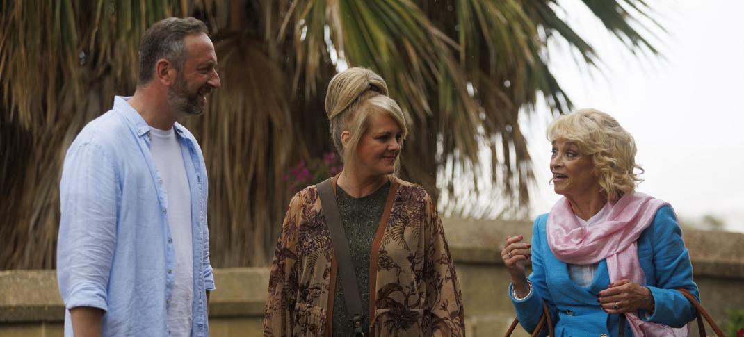 Steve Edge as Dom Hayes, Sally Lindsay as Jean White, and Sue Holderness as Judith Lloyd James arrive at the hotel in 'The Madame Blanc Mysteries' Season 3