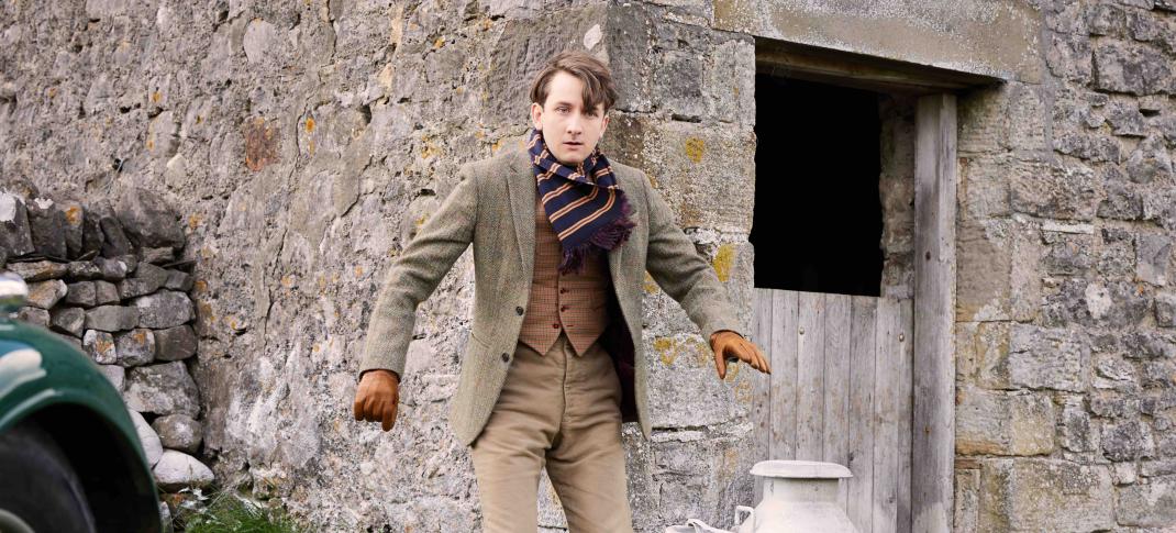 Picture shows: Richard Carmody (James Anthony-Rose) looks typically nervous on a farm visit. He's outside a barn next to some milk churns.