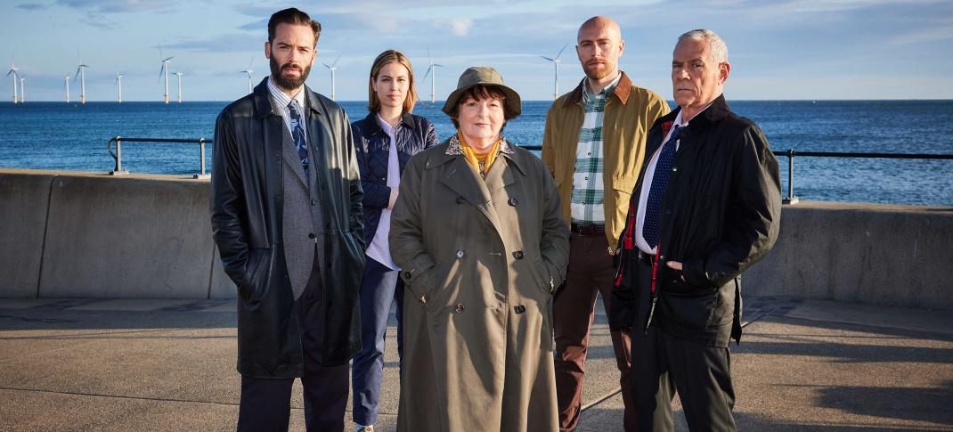 David Leon as DI Joe Ashworth, Rhiannon Clements as Steph, Brenda Blethyn as DCI Vera Stanhope, Riley Jones as DC Mark Edwards, and Jon Morrison as DS Kenny Lockhart stand by the seawall in 'Vera' Season 13