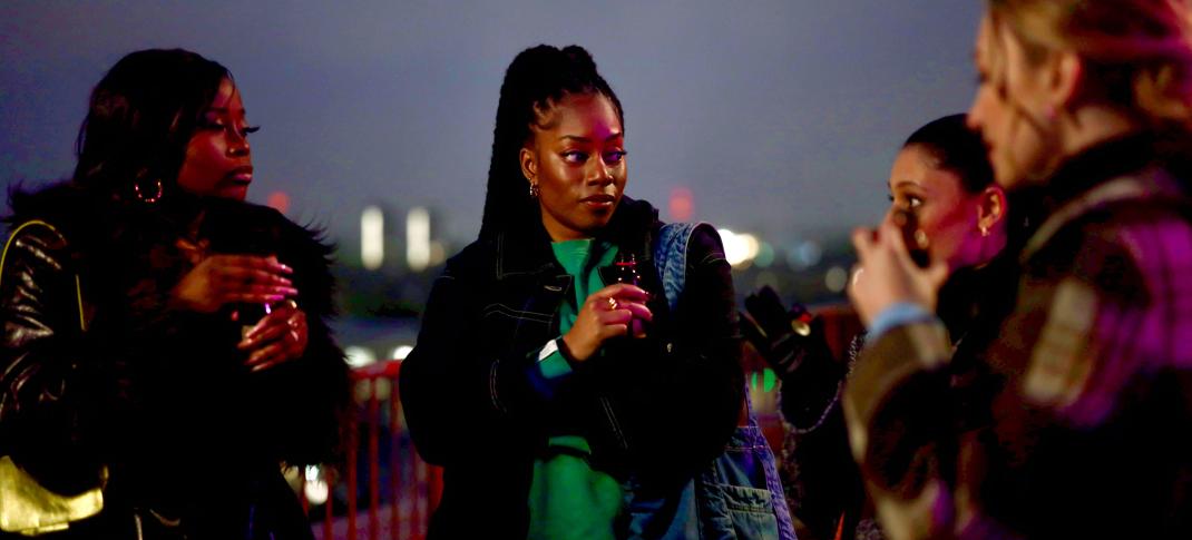 Dionne Brown as Queenie debates her future with her friends in 'Queenie'