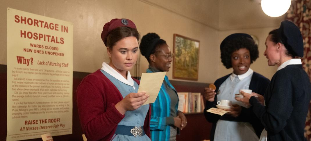 Megan Cusack as Nurse Nancy Corrigan reads a letter as Renee Bailey as Joyce Highland chats over coffee in 'Call the Midwife' Season 13, Episode 2