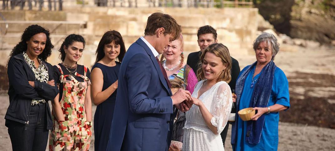 Jade Harrison as CS Charlie Woods, Melina Sinadinou as Zoe Williams, Zahra Ahmadi as DS Esther Williams, Kris Marshall as DI Humphrey Goodman, Sally Bretton as Martha Lloyd, Felicity Montagu as Margo Martins, Dylan Llewellyn as PC Kelby Hartford and Barbara Flynn as Anne Lloyd in the 'Beyond Paradise' Season 2 finale wedding